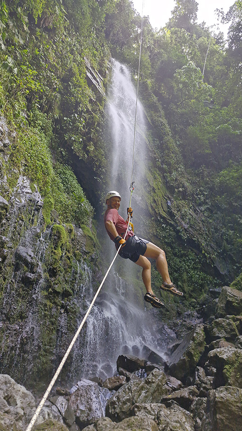 Waterfall cascading through lush vegetation